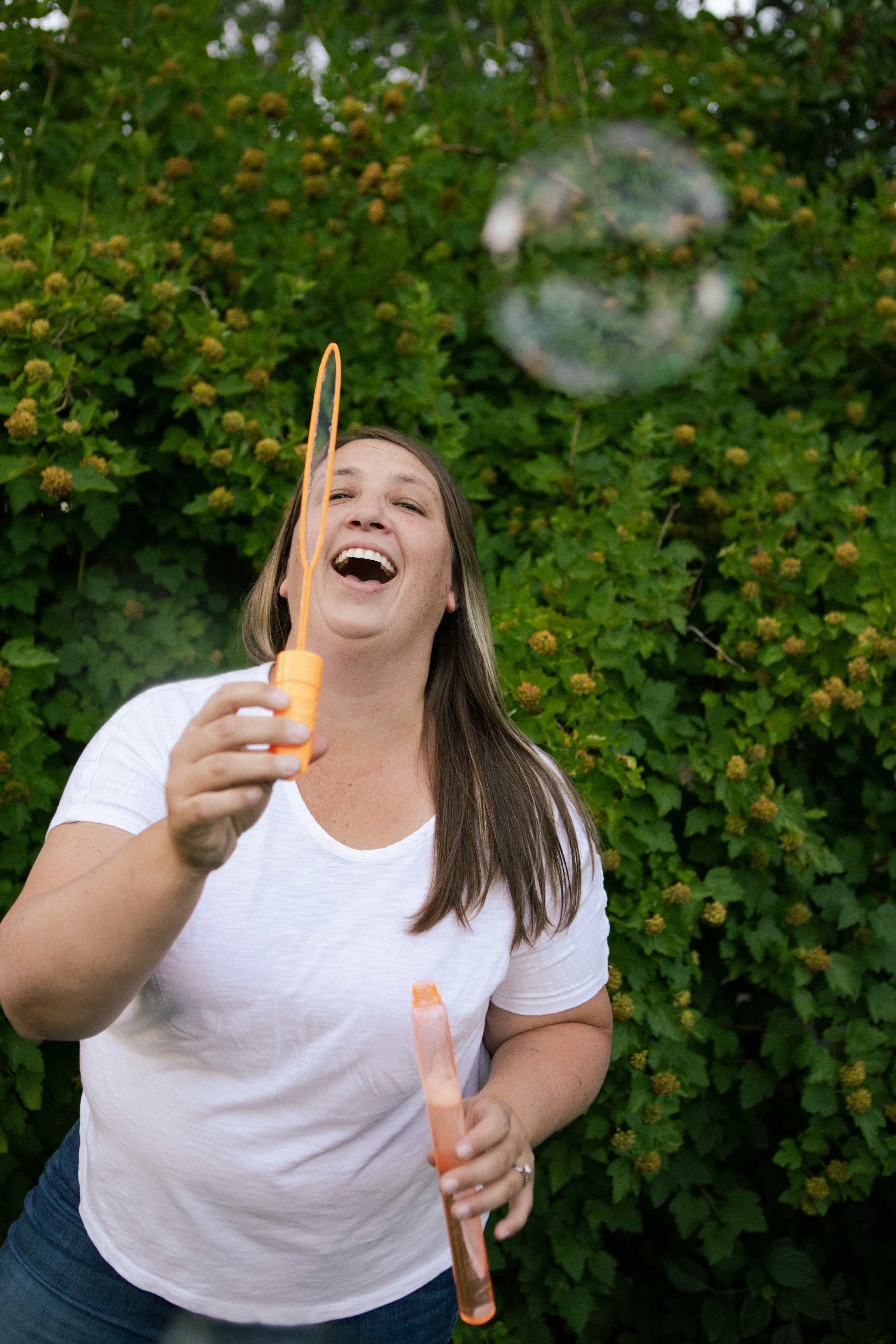 Kris blowing bubbles in a beautiful park